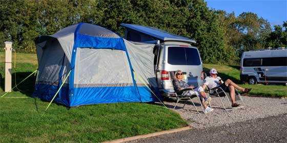 Couple relaxing on adults only touring pitch at York Naburn Lock Caravan Park